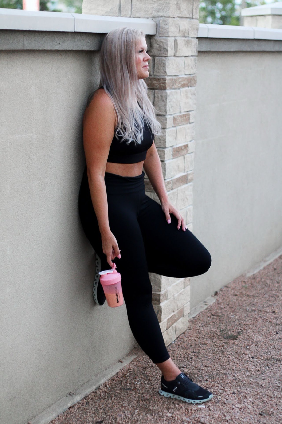 LadyBoss woman outside holding a pink shaker bottle